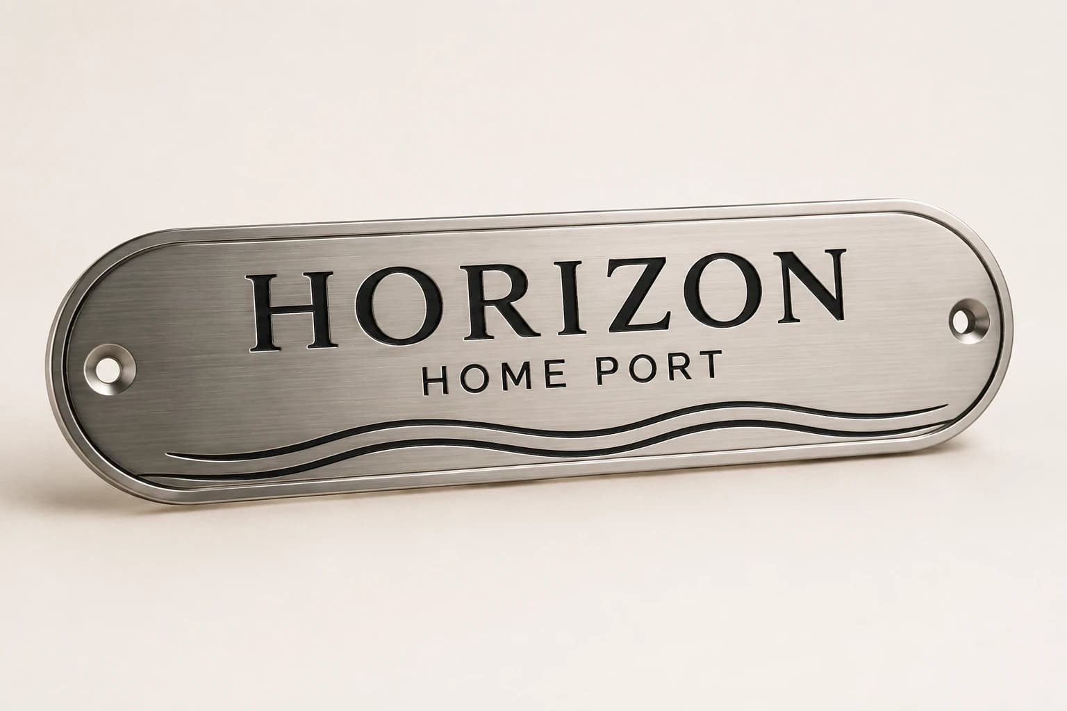 Brushed metal boat-name concept with wave engraving and rounded ends.